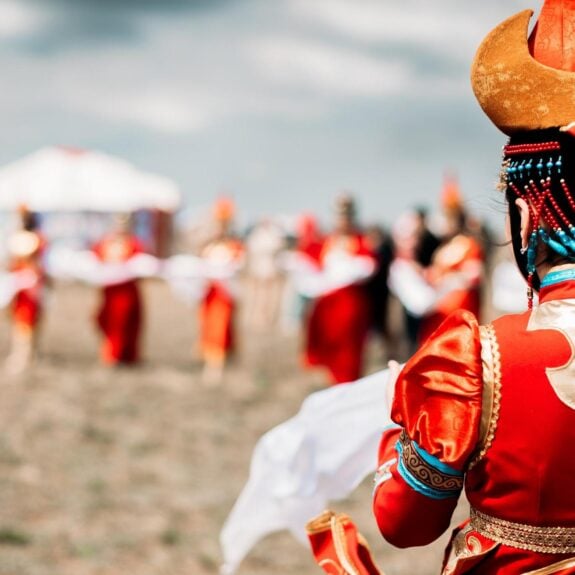 Photo of young beautiful women wearing in traditional national Mongolian Kalmykian dresses in the festival.