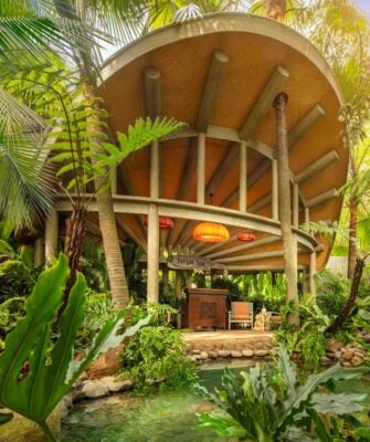 Exterior shot of hotel spa building - a large circular building with wooden front desk and chairs