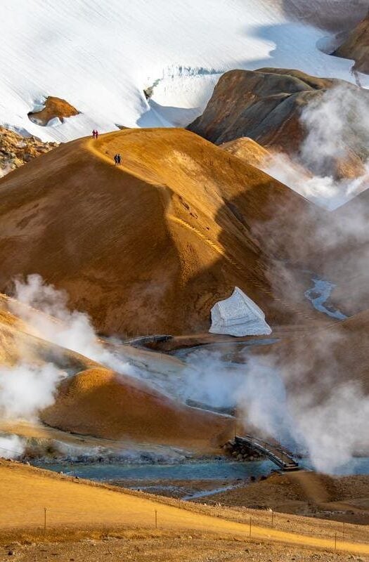 Rusty red rock dunes in Kerlingarfjöll, Iceland, a geothermal active place with clouds of sulphuric steam billowing out of the Earth