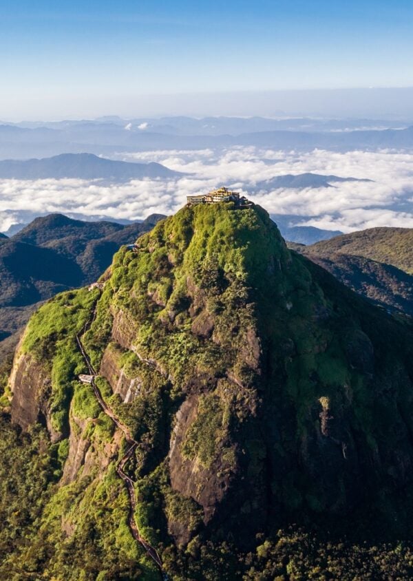 Adam's Peak is a 2243 m tall conical mountain located in central Sri Lanka - Sacred Mountain for four religions with a temple on the top. Aerial flying drone sh