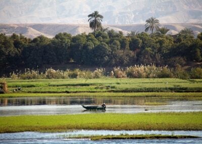 Landscape along the Nile river between Luxor and Aswan, Egypt. Landscape and fisherman