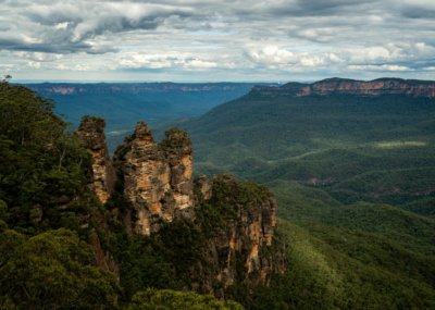 The Blue Mountains in Australia, a wilderness with thick carpets of forest covering mountainsides, and the famous Three Sisters rock formation visible