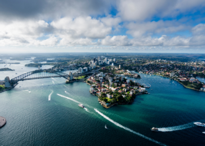 Aerial view of Sydney Harbour, with the Harbour Bridge and ferries in the water