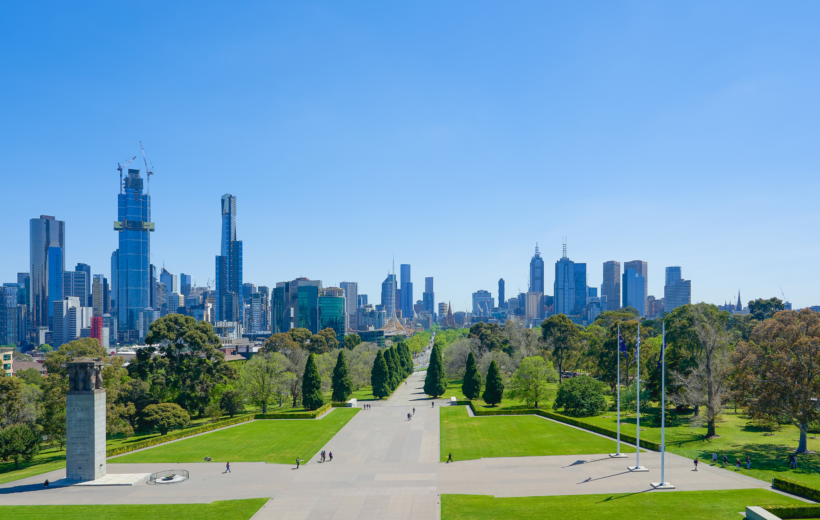 Melbourne city skyline, with a large green park in the foreground and skyscrapers in the background