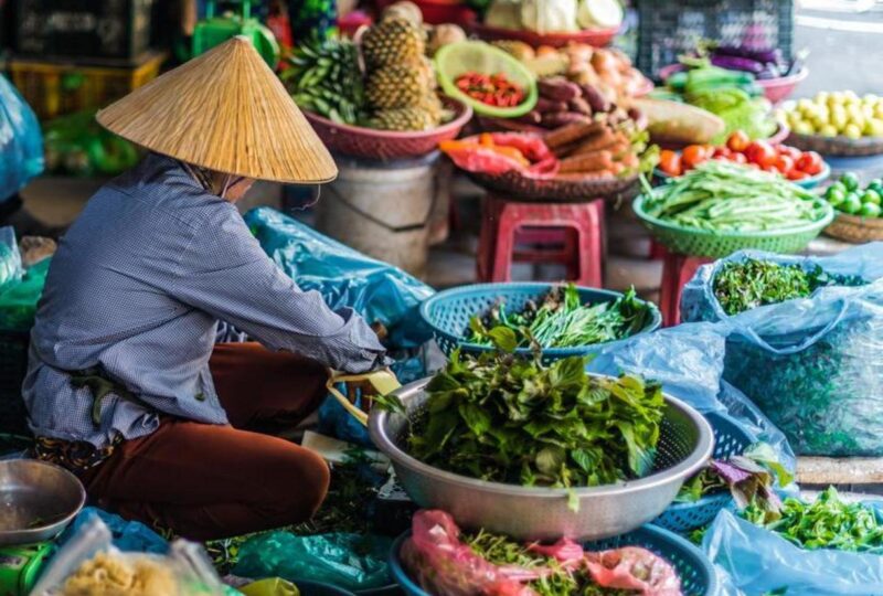 Women selling food on the street of Hoi An, Vietnam