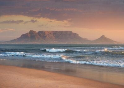 Sunset on a beach near Cape Town, with Table Mountain in the background