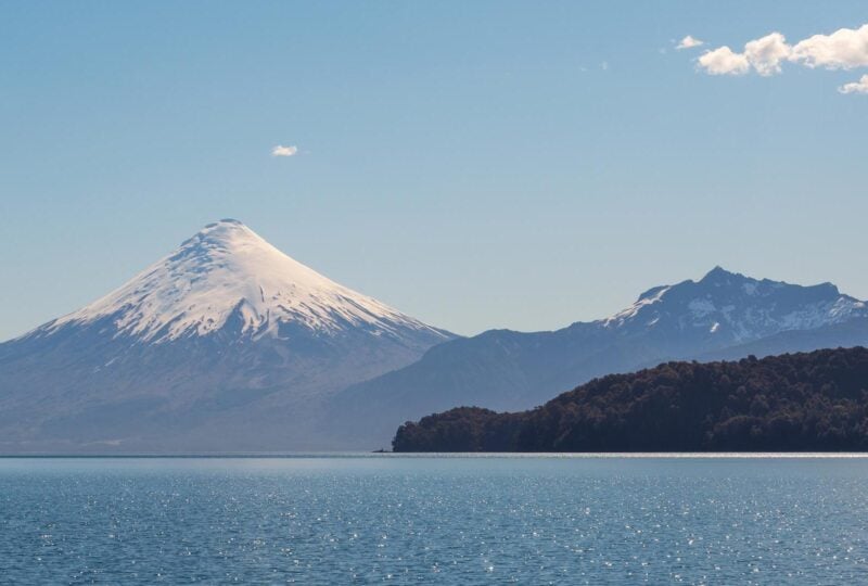 A lake with a snow-capped volcano in the background in Chile's Lake District