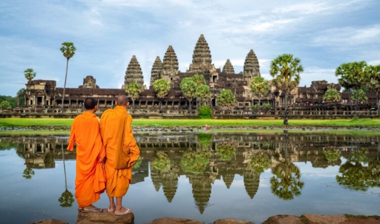 Asian monk stand and look to Angkor wat in siem reap, Cambodia, this image can use for travel and landmark in Asia