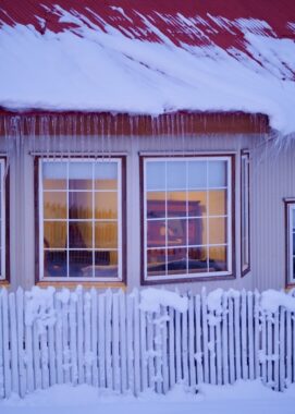 A window below a snow covered roof at Estancia Cerro Guido, Chile