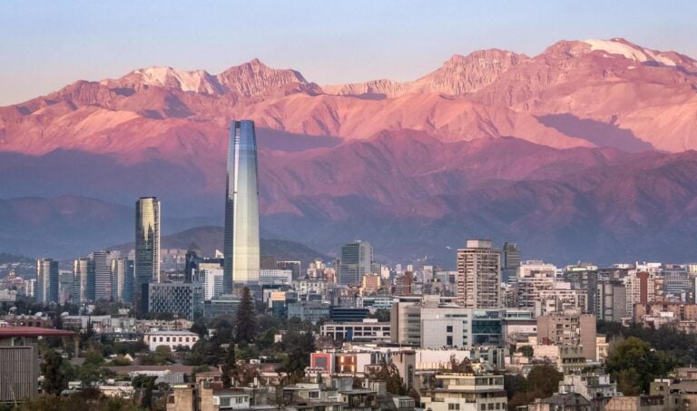 The skyline of Santiago, Chile at sunset, with mountains in the background