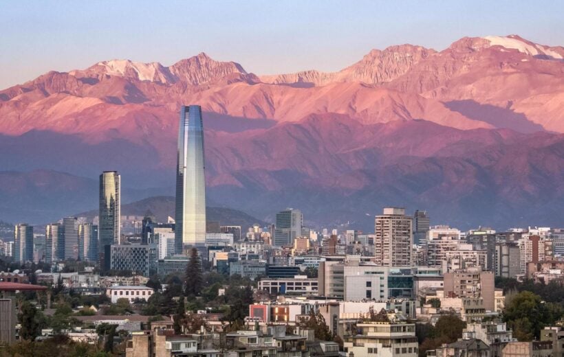 The skyline of Santiago, Chile at sunset, with mountains in the background