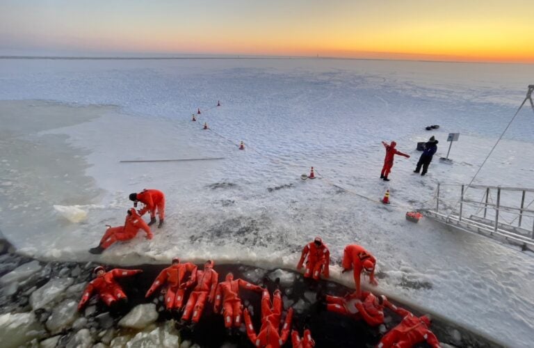 Swimming in survival suits in Finnish Lapland