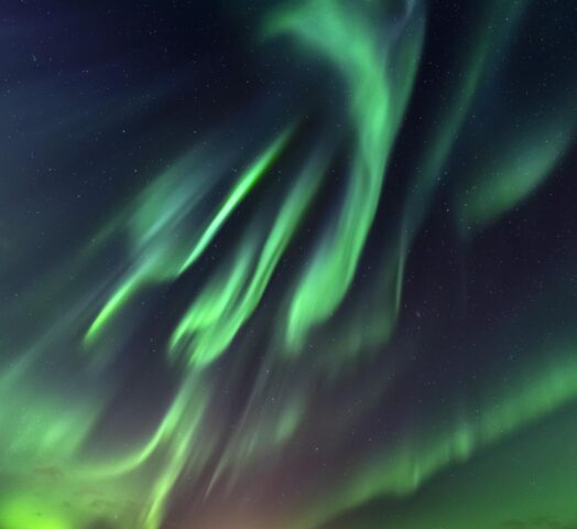 Green northern lights in the night sky