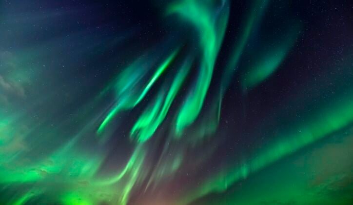 Green northern lights in the night sky