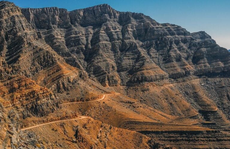 A road winding through cliffs in the Musandam Peninsula, Oman