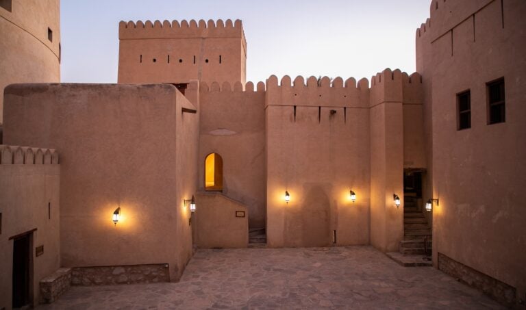 Nizwa fort lit up at nightfall