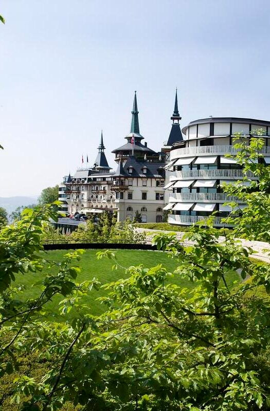 The Dolder Grand hotel in Switzerland surrounded by greenery