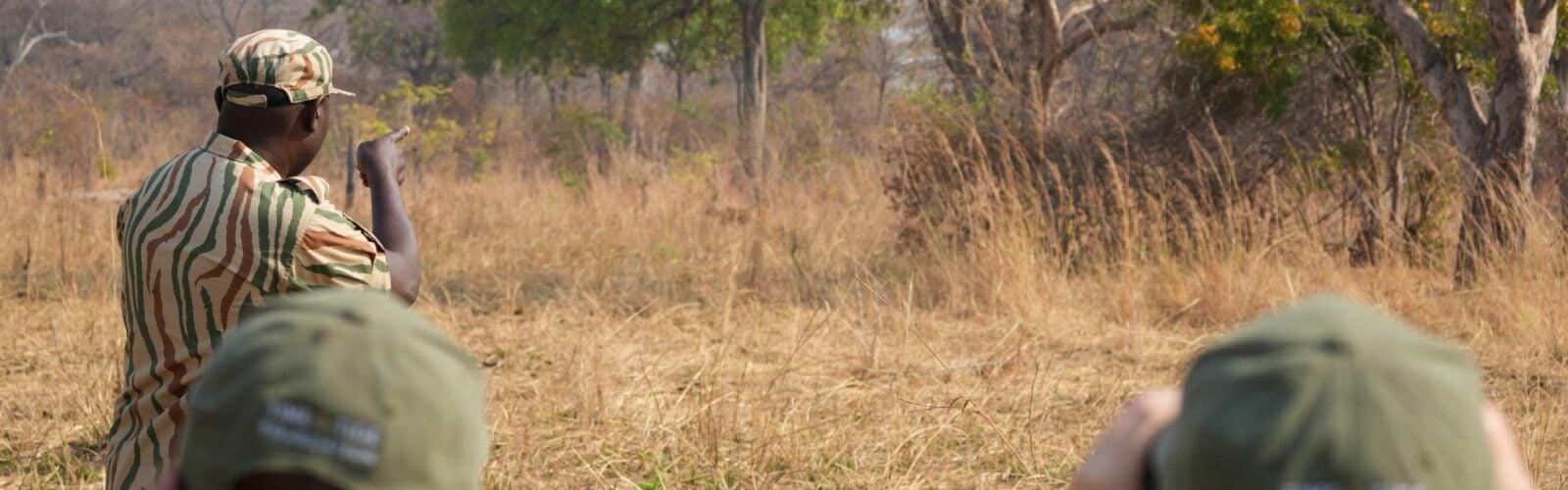 People with a guide on a walking safari in Zambia