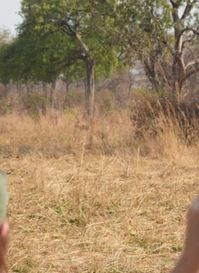 People with a guide on a walking safari in Zambia