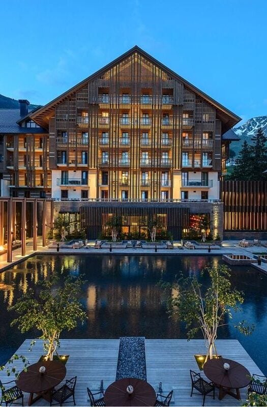 Exterior of The Chedi Andermatt lit up at dusk