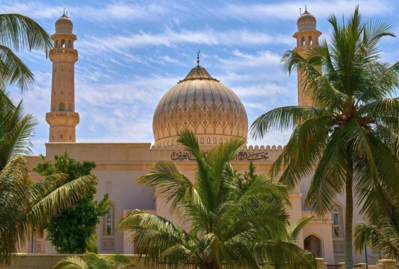 The Sultan Qaboos Mosque in Muscat fringed by palm trees