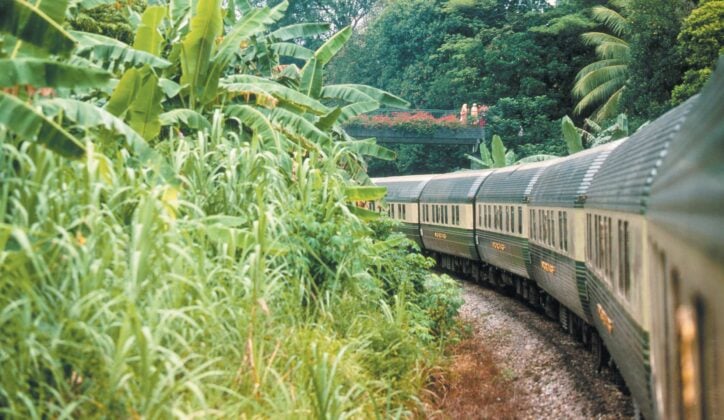 The Belmond Eastern & Oriental Express train travelling through the jungle