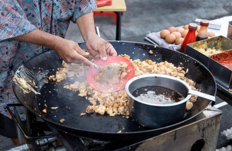 A hawker cooking traditional food in Singapore