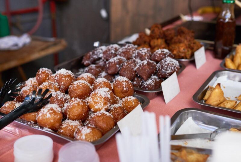 Balls of koeksisters dusted in coconut are for sale at a South African market