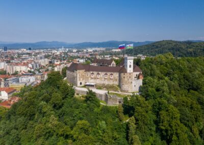 Ljubljana Castle and old town in Slovenia. Ljubljana is the largest city. It's known for its university population and green spaces, including expansive Tivoli Park. The curving Ljubljanica River.