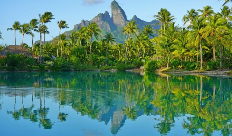 View of the Mont Otemanu mountain reflecting in water at sunset in Bora Bora, French Polynesia, South Pacific