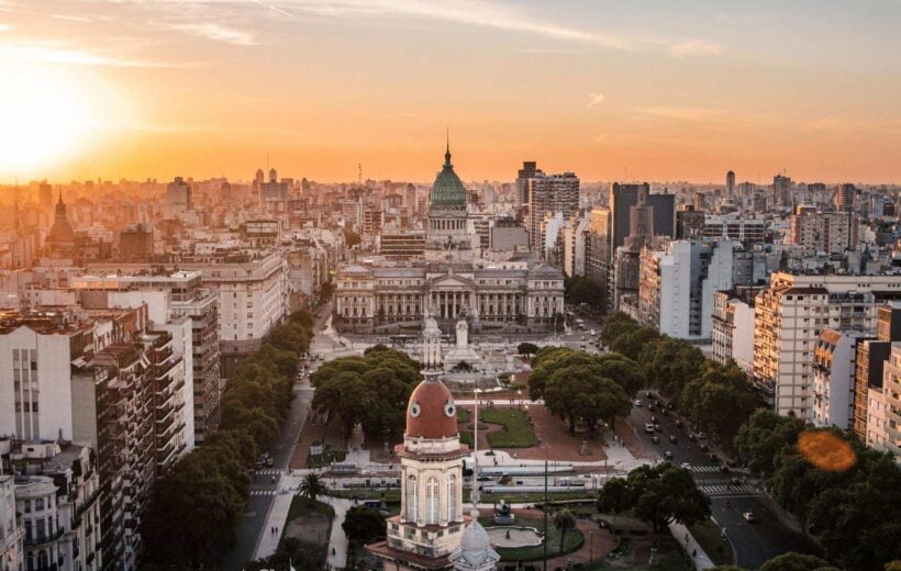 Aerial view of Buenos Aires cityscape at sunset with Congress building in focus.