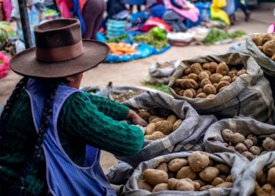 A woman selling potatoes at a market in Cusco