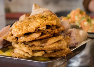 Pile of fried milanesas (milanese) in a market of Sucre, Bolivia