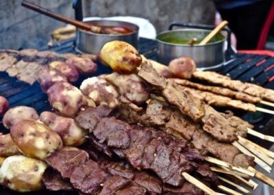 Grilled meat on skewers with potatoes in Peru