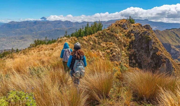 A couple trekking through rocky landscapes in Peru