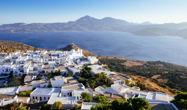 Aerial view of the ocean and white houses in Milos, Greece