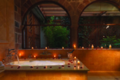 A bath tub with candles and rose petals in Belmond Hotel Monasterio, Peru