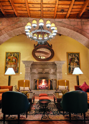 Hotel lounge with fireplace at Belmond Hotel Monasterio, Peru