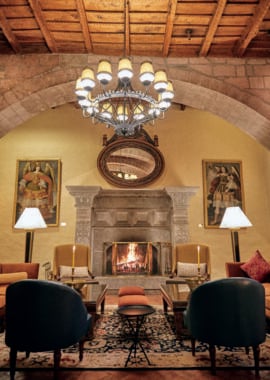 Hotel lounge with fireplace at Belmond Hotel Monasterio, Peru