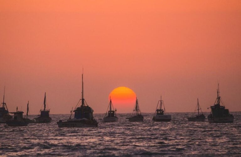 Fishing boats on the water at sunset in Mancora, Peru